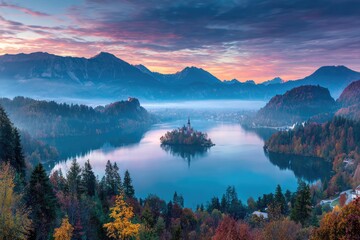 Serene sunrise over island church in misty lake, mountains in background