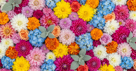 Colorful arrangement of dahlias, roses, hydrangeas, and marigolds set against soft green foliage creates a rich, vibrant pattern perfect for summer themes.