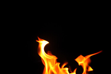 Close up burning flames on black background for graphic design or wallpaper.