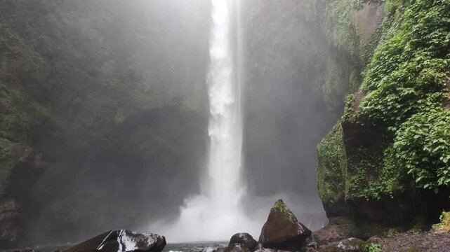 highest waterfalls in the middle of the forest with a very beautiful cliff, the name is Langkuik Tinggi waterfall in West Sumatra	