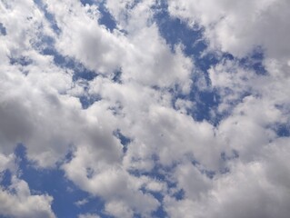clear blue sky with a few clouds. The sky is very bright and the clouds are scattered throughout	