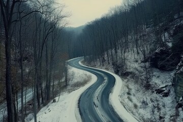 Curvy secluded winter road winding through a tranquil forest landscape in a snowy setting, Aerial establishing shot of a curvy secluded road during the winter Cinematic