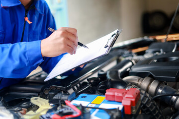 Check and inspect the condition of the car engine in detail. The mechanic is writing on a clipboard...