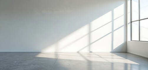 Obraz premium Empty office interior with white walls and concrete floor. Large window casts geometric shadows across the room. Minimalist, neutral space ideal for business concepts or architectural visualization.