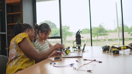Students and educators from different cultural backgrounds participate in interactive robotics lessons at a cutting-edge science and technology school, using laptops to program and operate smart robot