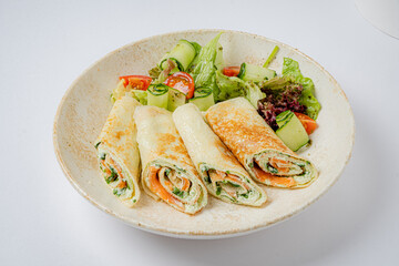 Herb and vegetable-stuffed pancakes with a vibrant salad make a delightful meal