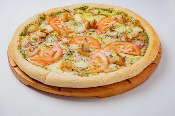 A delicious pizza with juicy tomatoes, chicken, and fresh herbs, ready to enjoy!