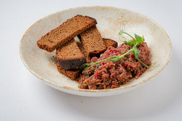 A plate of spiced minced meat and toasted bread showcases culinary artistry