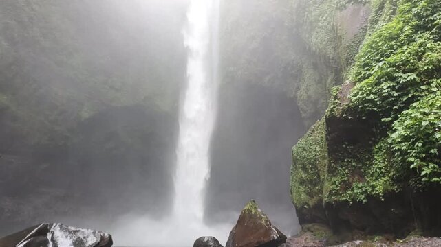 highest waterfalls in the middle of the forest with a very beautiful cliff, the name is Langkuik Tinggi waterfall in West Sumatra	