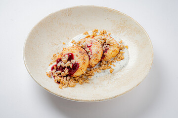 A delightful dish showcasing tender fruit stuffed with sweet filling, topped with granola
