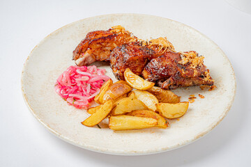 Roasted chicken with golden potatoes and pickled onions makes a delightful meal