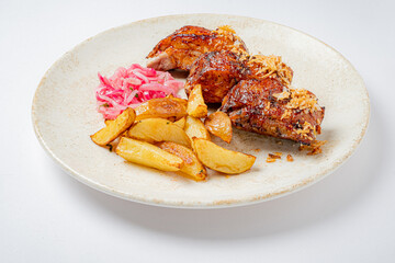 Savor grilled chicken with crispy potato wedges and tangy pickled onions