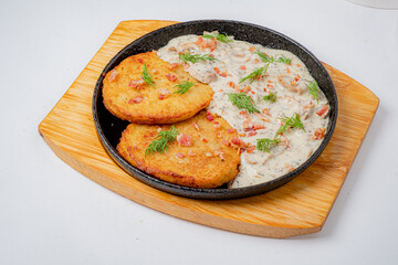 Delicious fritters plated beside a rich mushroom sauce, enhancing the culinary experience