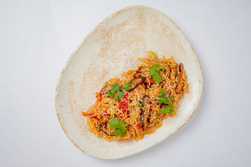 A vibrant dish of vegetable fried rice garnished with fresh herbs, highlighting colorful veggies