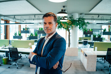 Confident businessman standing at office