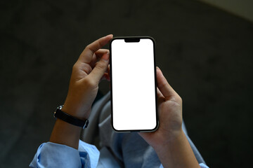 Close up view of person holding smartphone with empty screen, for advertising