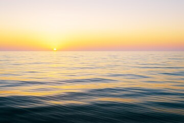 Fototapeta premium Peaceful ocean view with gentle waves and golden sunset light on horizon, showcasing serene natural landscape and calm seascape concept background.