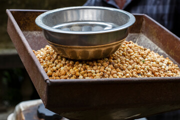 Traditional Sattu Preparation with Roasted Bengal Gram in Iron Grinder Bowl – Vegan Protein from Eastern