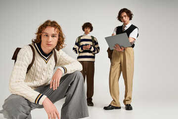 Young stylish friends sharing a moment in a creative studio space with modern fashion trends