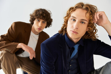 Stylish young friends showcasing modern fashion in a creative studio setting