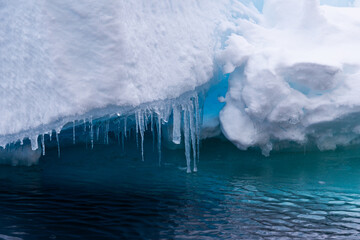 Blue light reflections and icicle n the arctic ice north of Svalbard, Norway © Reto Ammann