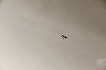 passenger Airplane in the Sky, sepia photo
