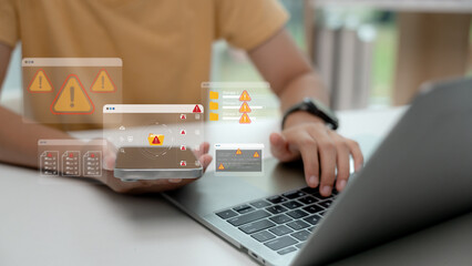 Close-up of person using smartphone and laptop with warning icons and error messages on screen. Concept of cyber threat, system error, data breach, malware, and digital security risk.