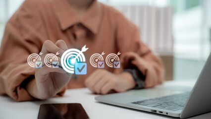 Business person using digital touchscreen to complete target checklist. Concept of goal achievement, productivity, planning, strategy, and successful business project management.