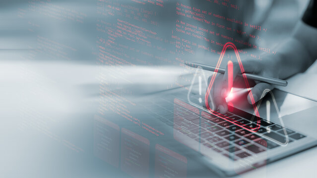 Close-up of hands coding on laptop with red warning alert icon and error code overlay. Concept of software bug, cyber threat, programming issue, system vulnerability, and security breach.