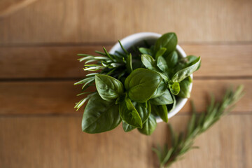 Top view fresh basil leaves on wooden table