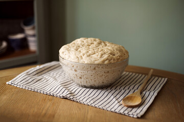 Rising dough in glass bowl, home baking