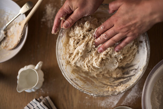 Female hands kneading dough for home baking