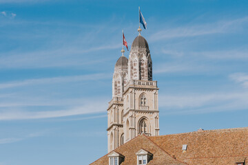 Fraumunster church showing swiss and Zurich flags waving in the wind
