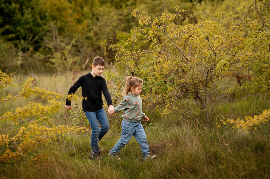 Kids exploring grassy path together.