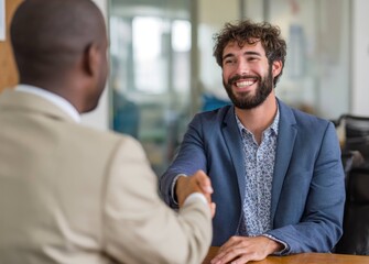 Obraz premium Happy businessman shakes hands with partner in modern office environment for successful collaboration