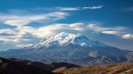 Snow-Covered Peak Elegance Under Azure Skies, Ethereal Clouds Framing Majestic Mountain, Dark Hills Adding Depth to Serene Landscape.