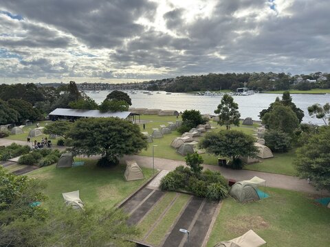 View of glamping tents on the ground next to the harbour, Cockatoo Island, Sydney, Australia