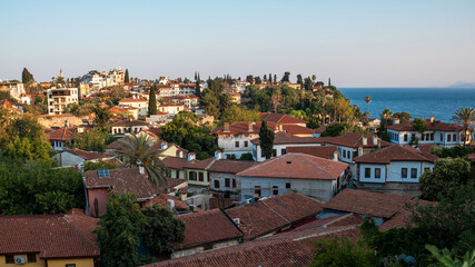 Obraz premium Colorful Rooftops and Coastal Views in a Mediterranean Town During Sunset