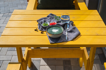 Traditional Russian lunch in a cafe. Top view of okroshka on a table in a summer cafe. 