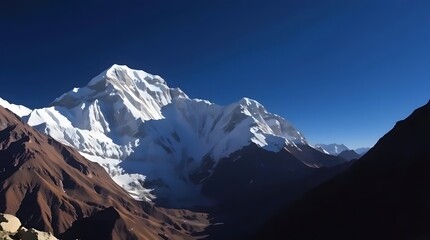 Fototapeta premium Majestic Snowcapped Mountain Peak Against Vivid Blue Sky