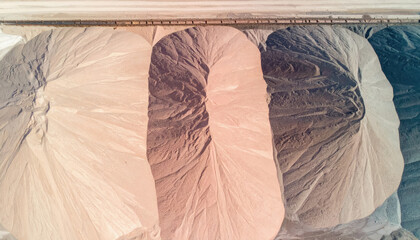 A pair of feet relaxing under the covers in a bed relating to mine tailings with copy space for text