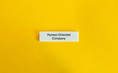 Human-Oriented Company Message on Minimal Yellow Background