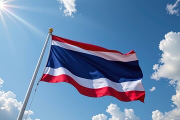 a dynamic perspective of the thai flag billowing strongly in the wind from below, highlighting the bold stripes and emphasizing strength, freedom, and determination.