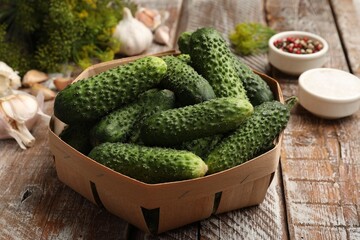 Making pickles. Fresh cucumbers and spices on wooden table, closeup