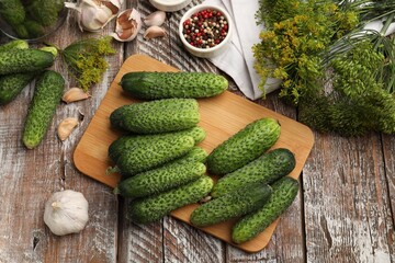 Making pickles. Fresh cucumbers and spices on wooden table, flat lay