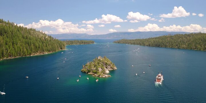 Lake Tahoe - Aerial View of Ferry Leaving Emerald Bay with Fluffy Clouds and Other Boats on Summer Day