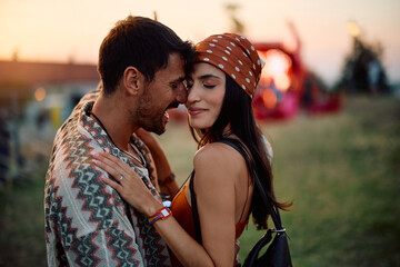 Young couple in love enjoying during open air music festival in summer.