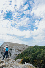 Fototapeta premium Male looking at the landscape from the top of a mountain on a hike