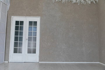 Interior of an empty beige room with a door