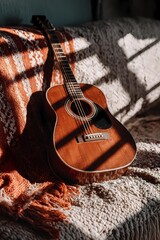Still life of a guitar nestled on a cushioned seat, combining musical presence with a soft, calm setting.